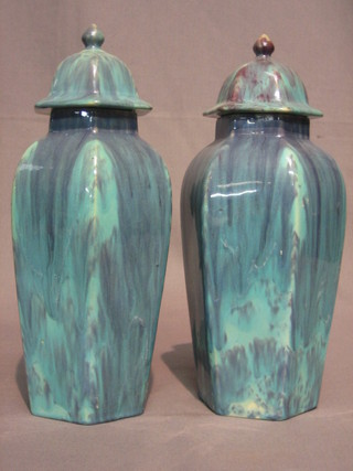 A pair of octagonal terracotta glazed urns and covers 13"