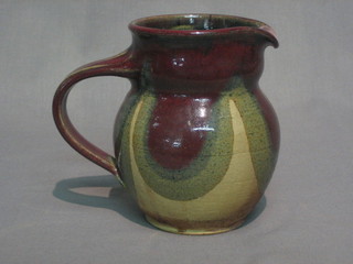 A plumb glazed Art Pottery jug, the base with signature mark  6"