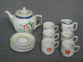 A  childs  1930's 13 piece tea service  comprising  teapot,  cream jug, 6 saucers and 5 cups