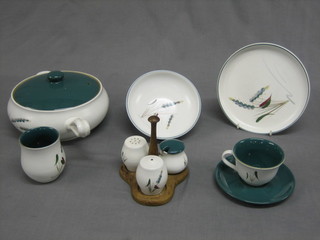 A  61  piece Denby dinner service with blue ears of  corn  design comprising  2  rectangular  platters 13  1/2",  10  circular  dinner plates 8", 6 pudding bowls 8 1/2", 2 saucepans 8" and 7",  butter dish and cover 8", 2 3 piece condiment sets 1 raised on a wooden stand,  a  crescent shaped salad dish 9", 3 jugs  4",  hotwater  jug 7", a vase 4", 2 sugar bowls 2", an open butter dish on stand  5", a cream jug 3", 12 cups and 12 saucers