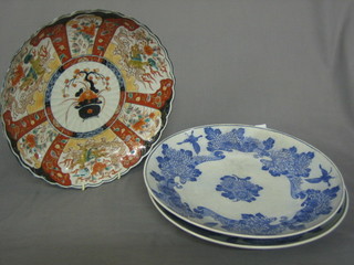 An Imari porcelain plate with panelled decoration and lobed body 12" and 2 Oriental blue and white porcelain dishes 13"