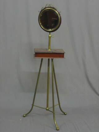 An  Edwardian  mahogany  and  brass  shaving  stand  the   upper section  with circular plate mirror, raised on a brass column,  the base fitted a rectangular mahogany twin compartment