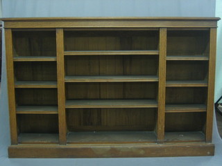 A  Victorian  honey oak bookcase fitted  adjustable  shelves  with reeded columns, raised on a platform base 72"