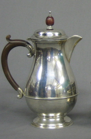 A   silver  hotwater  jug  of  baluster  form  with   beech   handle Birmingham 1931, 11 ozs