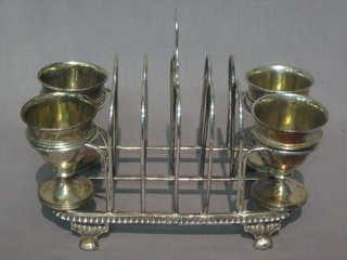 A  handsome  George III silver 5 bar toast  rack  incorporating  4 egg cups with parcel gilt interiors, raised on 4 hoof feet,  London  1812,    14    ozs   (1   bar   to   toast   rack    loose)   