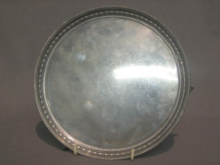 A Scots circular silver salver with embossed rim, raised on 3 ball and  claw  supports, Edinburgh 1932 by Hamilton & Co,  10  ozs