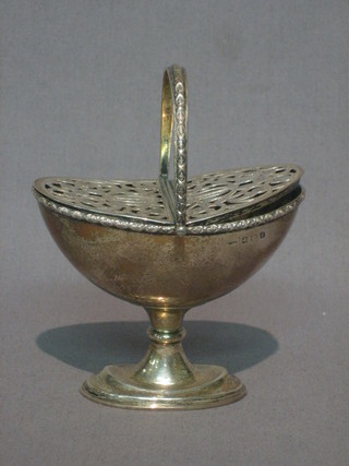An  Edwardian  silver incense or sugar boat with pierced  lid  and swing  handle,  raised on a circular spreading  foot,  Birmingham 1910 3 ozs