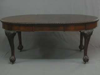 A  Georgian  style  mahogany oval  extending  dining  table  with gadrooned   border,  raised  on  carved  cabriole  ball   and   claw supports 70"