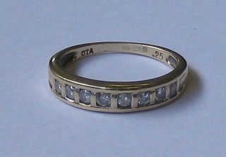 A 9ct gold half eternity ring set 8 small diamonds