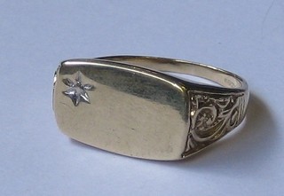 A gentleman's modern 9ct gold rectangular signet ring set a small diamond