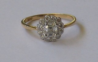 A lady's 18ct gold dress ring set a large central diamond surrounded by numerous diamonds (approx 0.70ct)