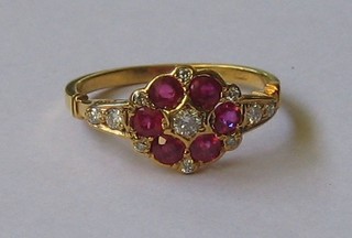 A lady's 18ct yellow gold dress ring set 6 rubies supported by numerous diamonds   