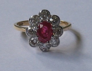 A lady's 18ct yellow gold dress ring set an oval ruby supported by 8 diamonds (approx. 1.20/1.40ct)