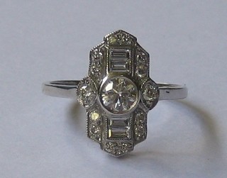 A lady's 18ct white gold Art Deco style dress ring set a large diamond to the centre flanked by 4 baguette cut diamonds and surrounded by numerous other diamonds (approx. 0.75ct)