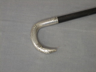 A Continental hardwood walking stick with embossed silver handle