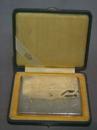 An Oriental silver cigarette case with engraved decoration, cased