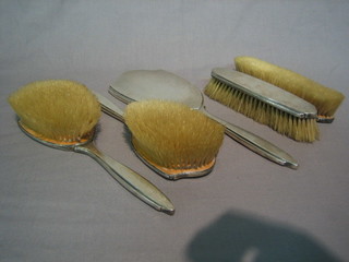 An Art Deco 5 piece silver backed dressing table set with engine turned decoration comprising hand mirror, pair of hair brushes, pair of clothes brushes, Birmingham 1929