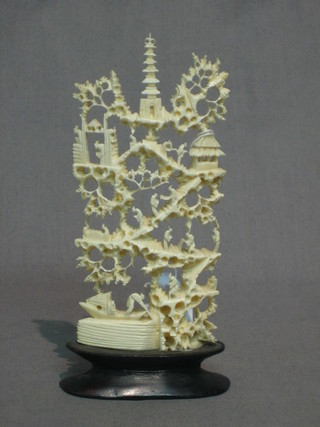 A section of carved ivory in the form of a sculpture depicting temples etc 4"