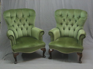 A pair of mahogany tub back armchairs upholstered in green buttoned material, raised on cabriole supports
