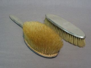 A silver backed hair brush and a clothes brush