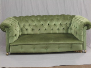 A Chesterfield upholstered in green buttoned material 75"