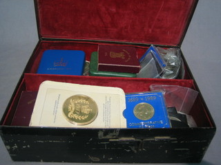 A collection of various coins contained in a metal box