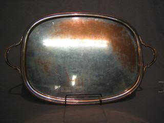 An oval silver plated twin handled tea tray raised on panelled feet 20"