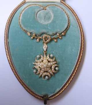 A handsome gold pendant/brooch set demi-pearls hung on a fine gold chain