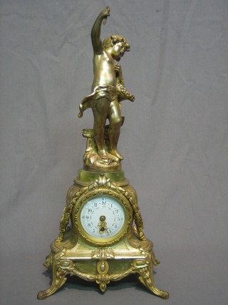 A French 19th Century 8 day mantel clock with porcelain dial and Arabic numerals contained in a gilt spelter case surmounted by a figure of a standing cherub