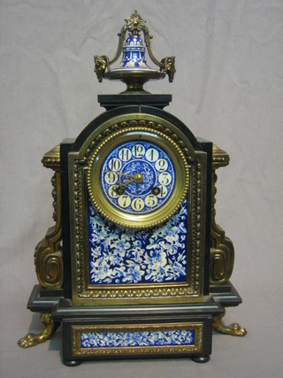 A 19th Century French 8 day striking mantel clock with Arabic numerals contained in a wooden arch shaped case with blue and white floral porcelain panels
