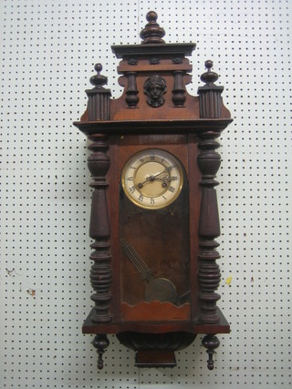 A Vienna style striking regulator with paper dial and Roman numerals contained in a walnut case