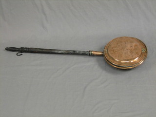 An 18th/19th Century copper warming pan with turned handle
