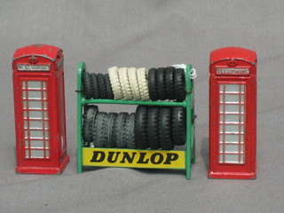 A "Dinky" metal Dunlop tyre rack complete with contents of tyres together with 2 Dinky red telephone boxes