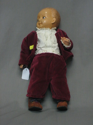 A celluloid boy doll wearing a velvet suit 15"