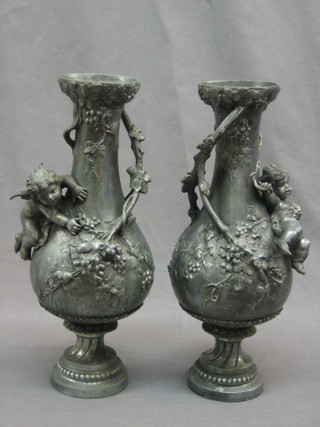 A pair of 19th Century pewter vases of club form with cherub and grape decoration 12"