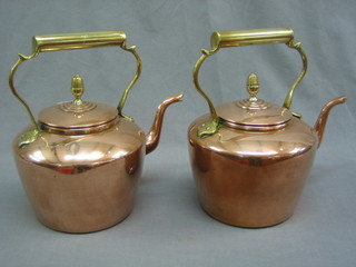 A pair of 19th Century copper kettles with brass handles