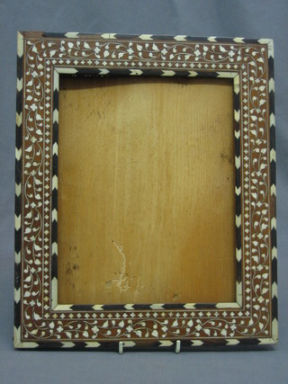 An Eastern hardwood and inlaid ivory photograph frame 13" x 11"