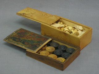 A wooden chess set and a turned wooden draft's set