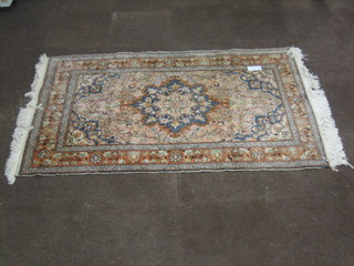 A pink Persian carpet with multi-row borders 75" x 46"