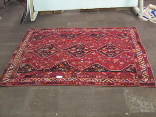 A contemporary red ground Shiraz carpet with 3 diamonds to the centre 108" x 82"    