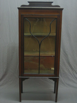 An Edwardian inlaid mahogany display cabinet enclosed by an astragal glazed door, raised on square tapering supports 24"