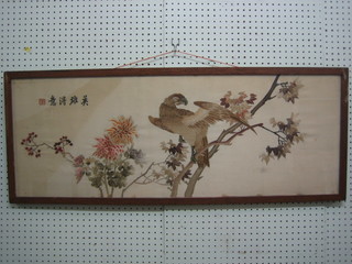 An Eastern silk panel depicting an eagle on a branch with 5 character signature 15" x 40" contained in an oak frame