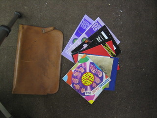 A leather document case containing various modern programmes, Wimbledon, Theatre etc