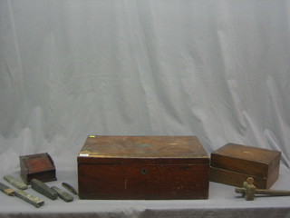 A rectangular wooden box with hinged lid 20" containing a wooden writing slope and a collection of cut throat razors etc