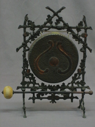 An Art Nouveau embossed copper tea gong raised on a stand