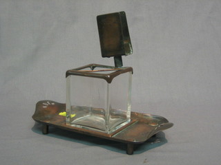 A square Art Deco glass match holder raised on a rectangular copper stand