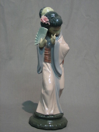 A Lladro figure of a standing Geisha girl with fan 11"
