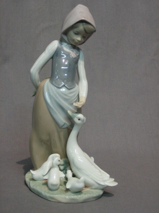 A Lladro figure of a standing girl feeding Geese 9"