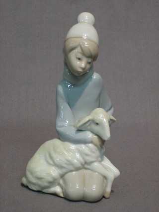 A Lladro figure of a kneeling shepherd boy with lamb 6"