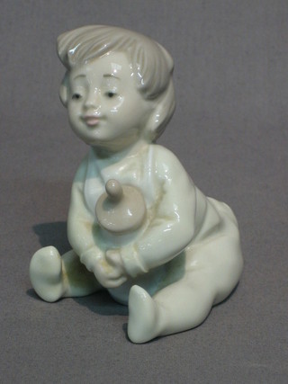 A Nao figure of a baby with bottle 4"